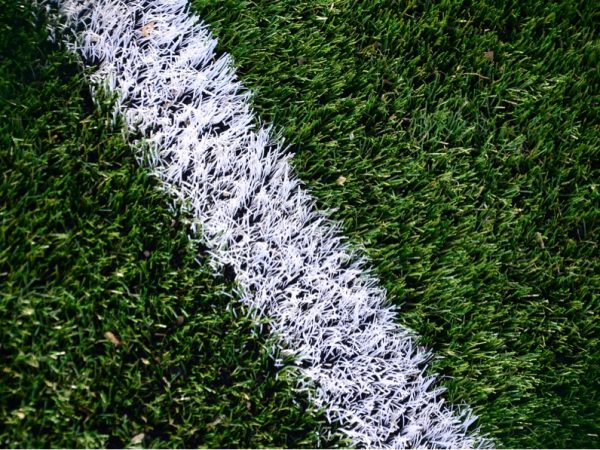 Kunstrasen nach einer Reinigung auf einem Fußballplatz